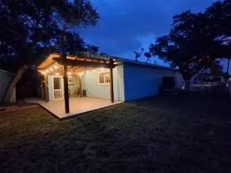 an aerial view of residential houses with outdoor space and trees
