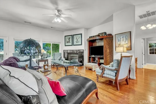a living room with furniture kitchen view and a large window