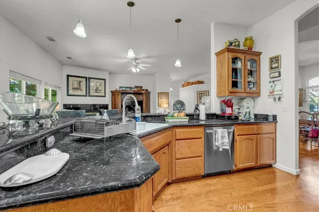 a view of a dining room with furniture a chandelier and wooden floor