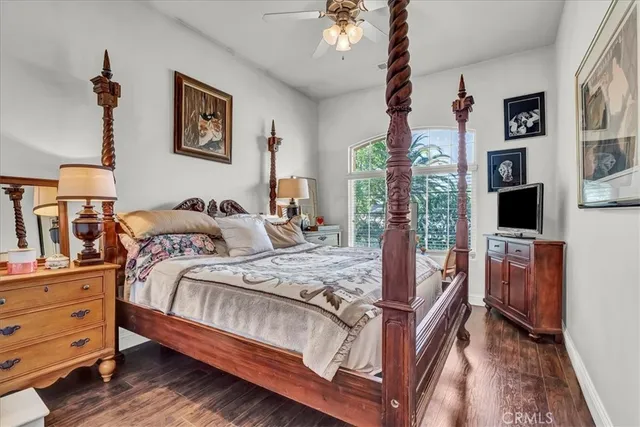 a view of a bedroom with wooden floor and cabinet