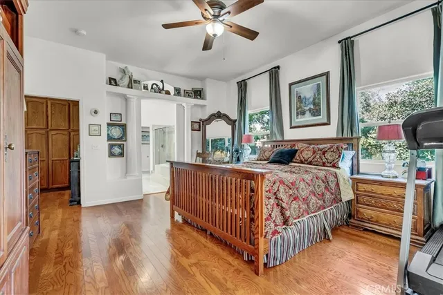 a spacious en suite bathroom with a double vanity sink a mirror and shower view