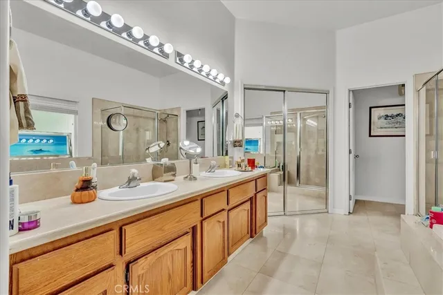 a bathroom with a tub a shower and a sink