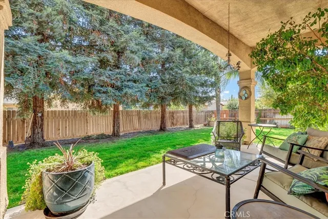 a view of a house with backyard and sitting area