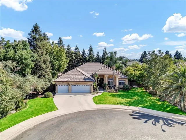 a front view of a house with a yard and a garage
