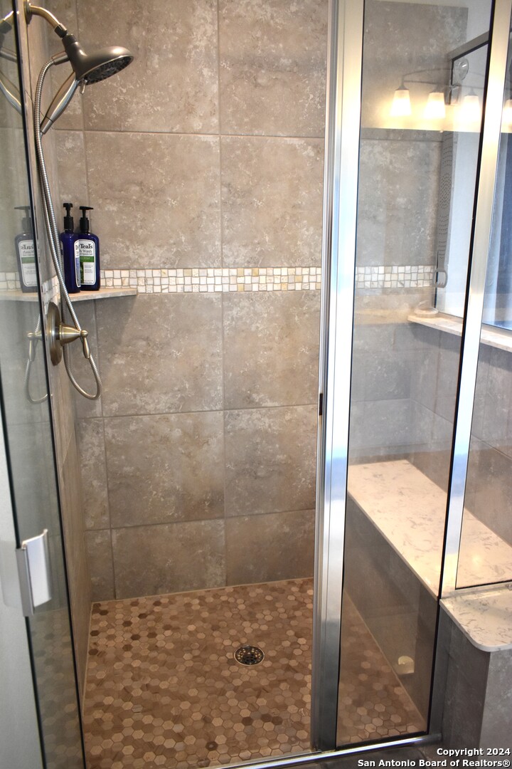 624 Colt Trail Schertz, TX 78154 - Photo 17 of 20 a bathroom with a glass shower door