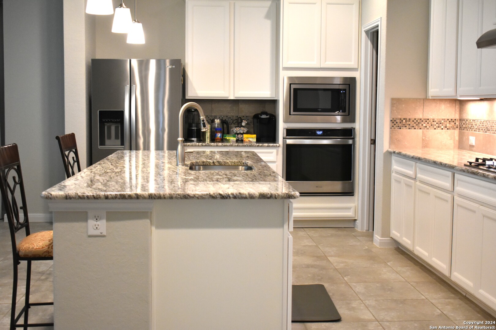 624 Colt Trail Schertz, TX 78154 - Photo 8 of 20 a kitchen with stainless steel appliances granite countertop a stove a sink and a refrigerator