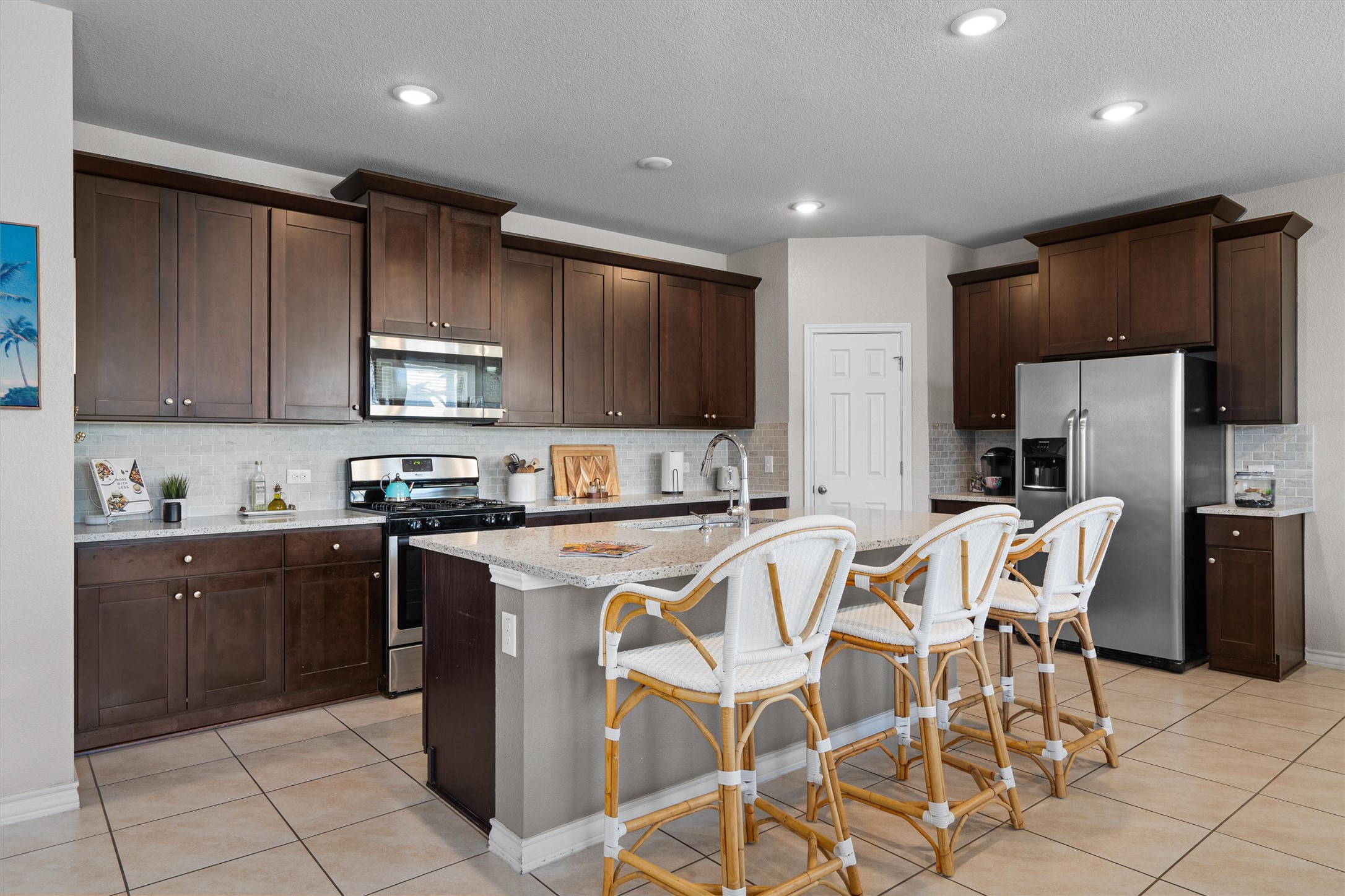 Undisclosed Address Buda, TX 78610 - Photo 11 of 39 a kitchen with stainless steel appliances granite countertop a stove a sink a refrigerator and a microwave