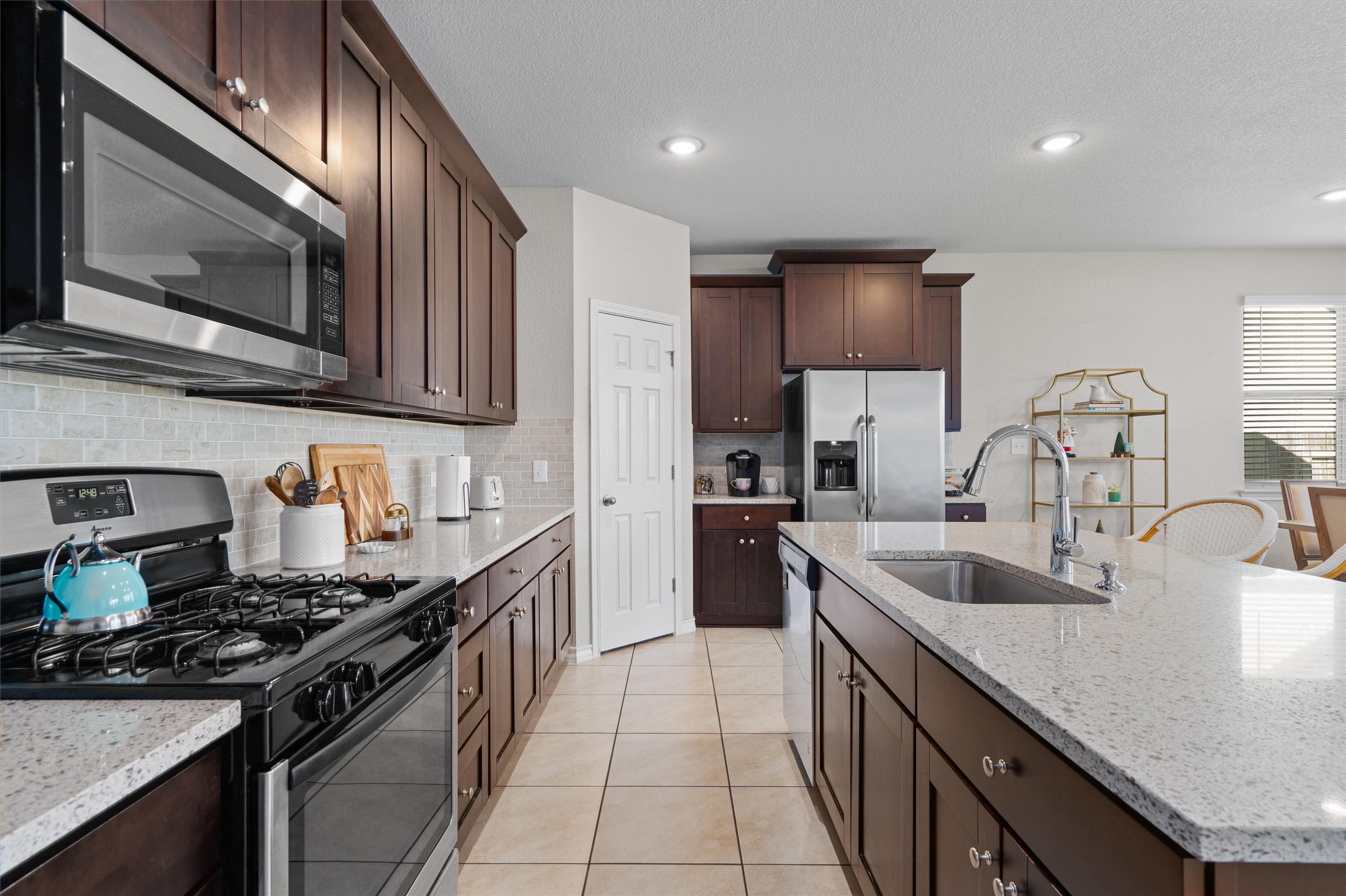 Undisclosed Address Buda, TX 78610 - Photo 12 of 39 a kitchen with stainless steel appliances granite countertop a sink stove and cabinets