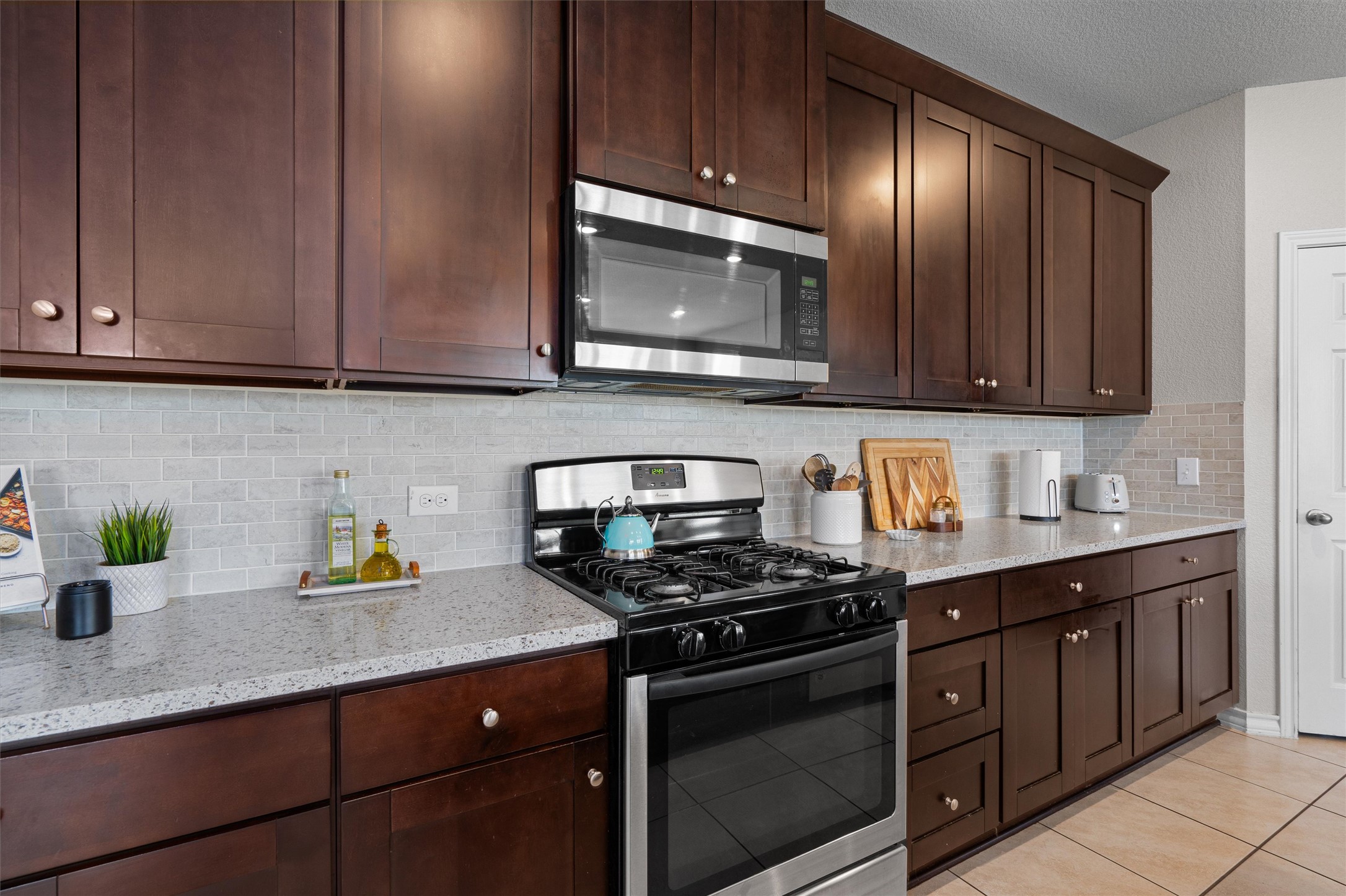 Undisclosed Address Buda, TX 78610 - Photo 15 of 39 a kitchen with stainless steel appliances granite countertop a sink a stove and cabinets