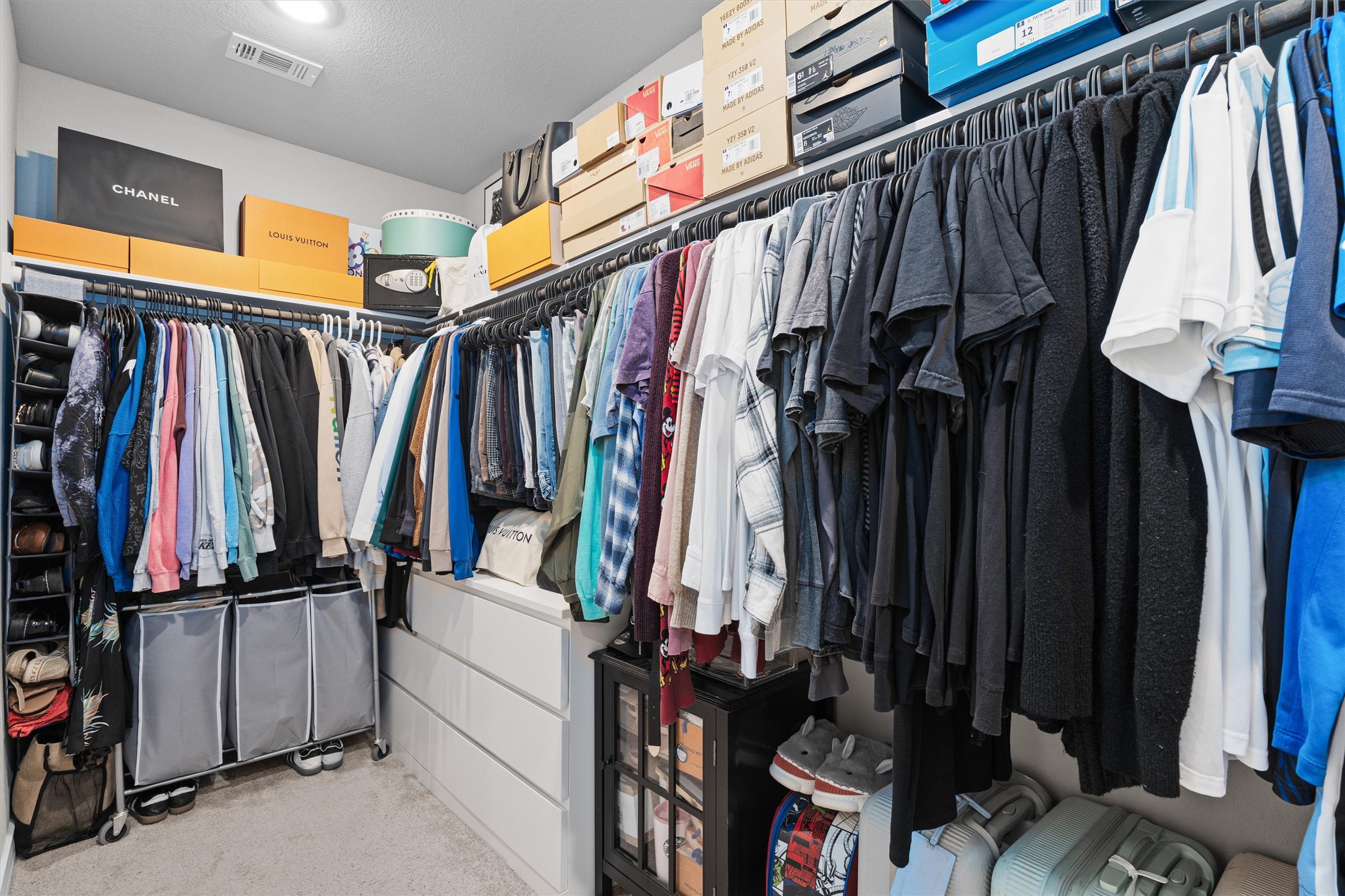Undisclosed Address Buda, TX 78610 - Photo 27 of 39 a view of walk in closet with clothes