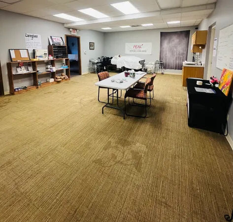 a living room with furniture gym equipment and a table