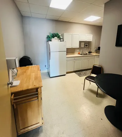 a workspace with furniture and kitchen