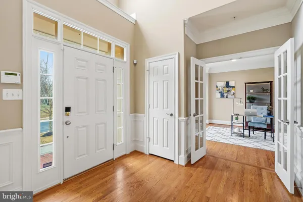 a living room with furniture and a hard wood floor