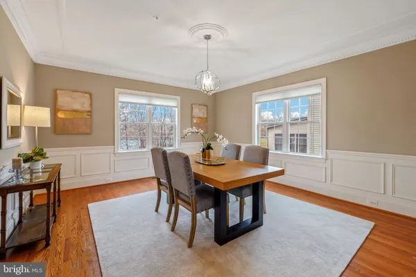 a view of a dining room with furniture and chandelier