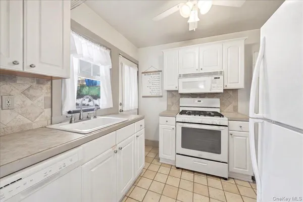 a kitchen with a stove a sink and a refrigerator