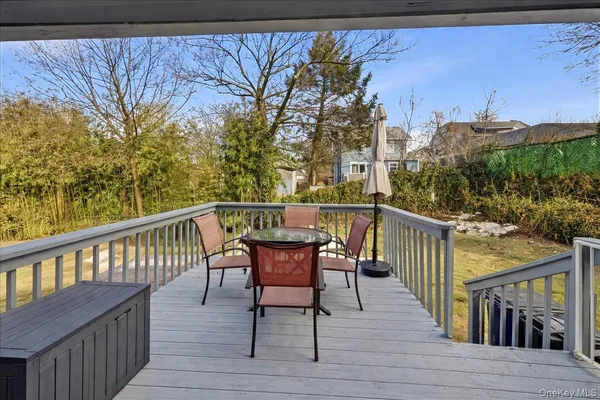 a view of a wooden chairs on the roof deck