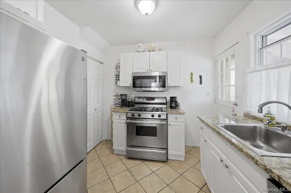 a kitchen with white cabinets and a stainless steel appliances