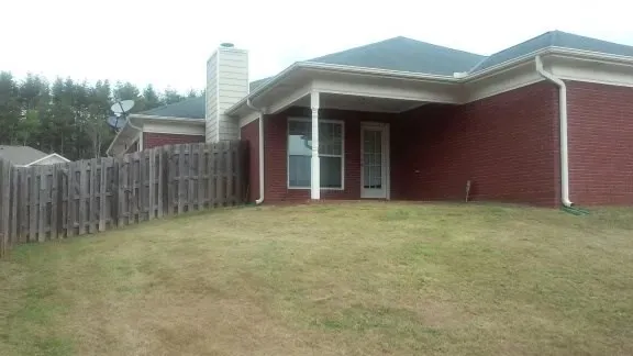 a view of a house with wooden fence