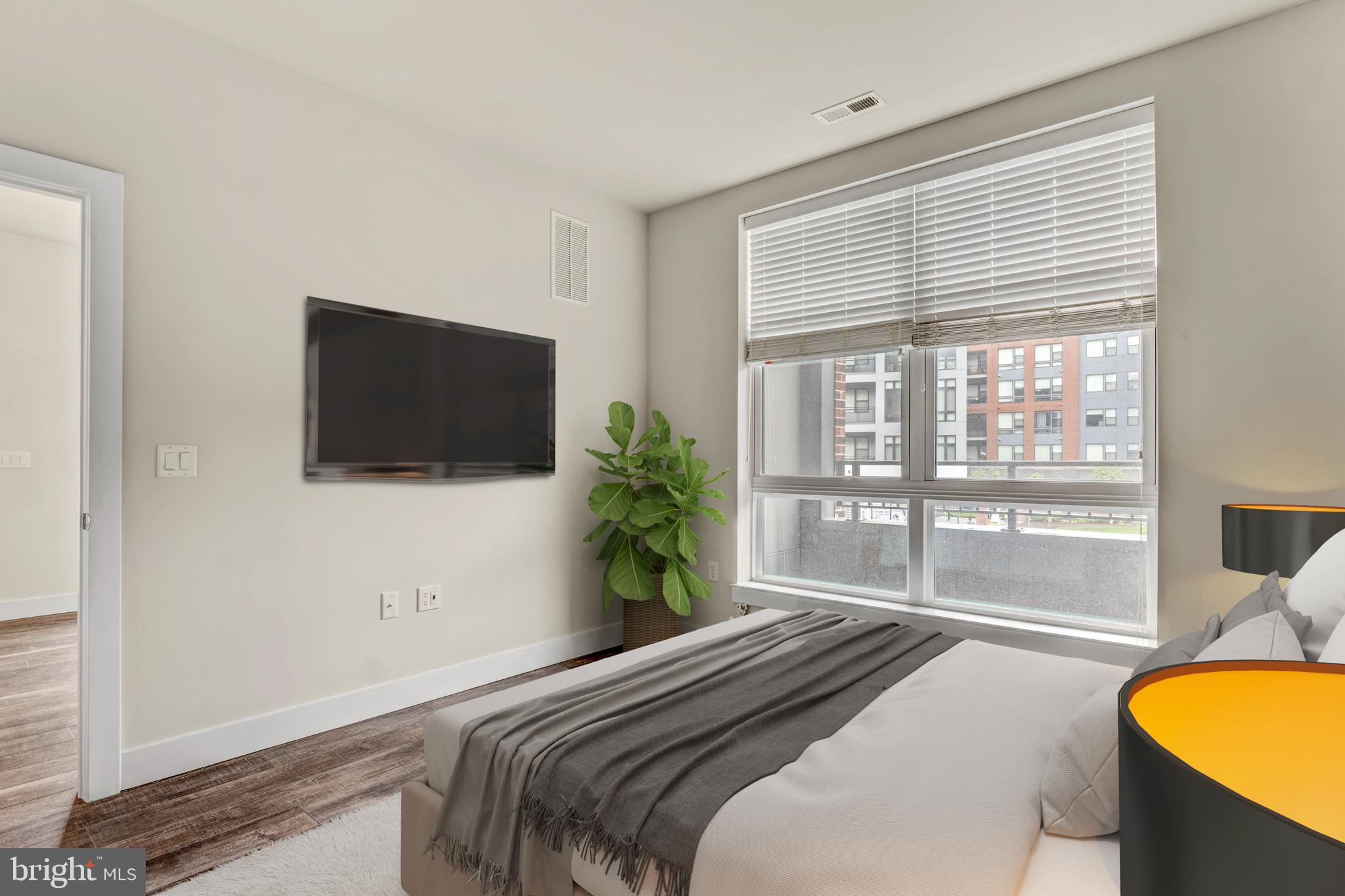 1761 Old Meadow Road, Unit 209 McLean, VA 22102 - Photo 13 of 49 a bedroom with a bed and a flat screen tv