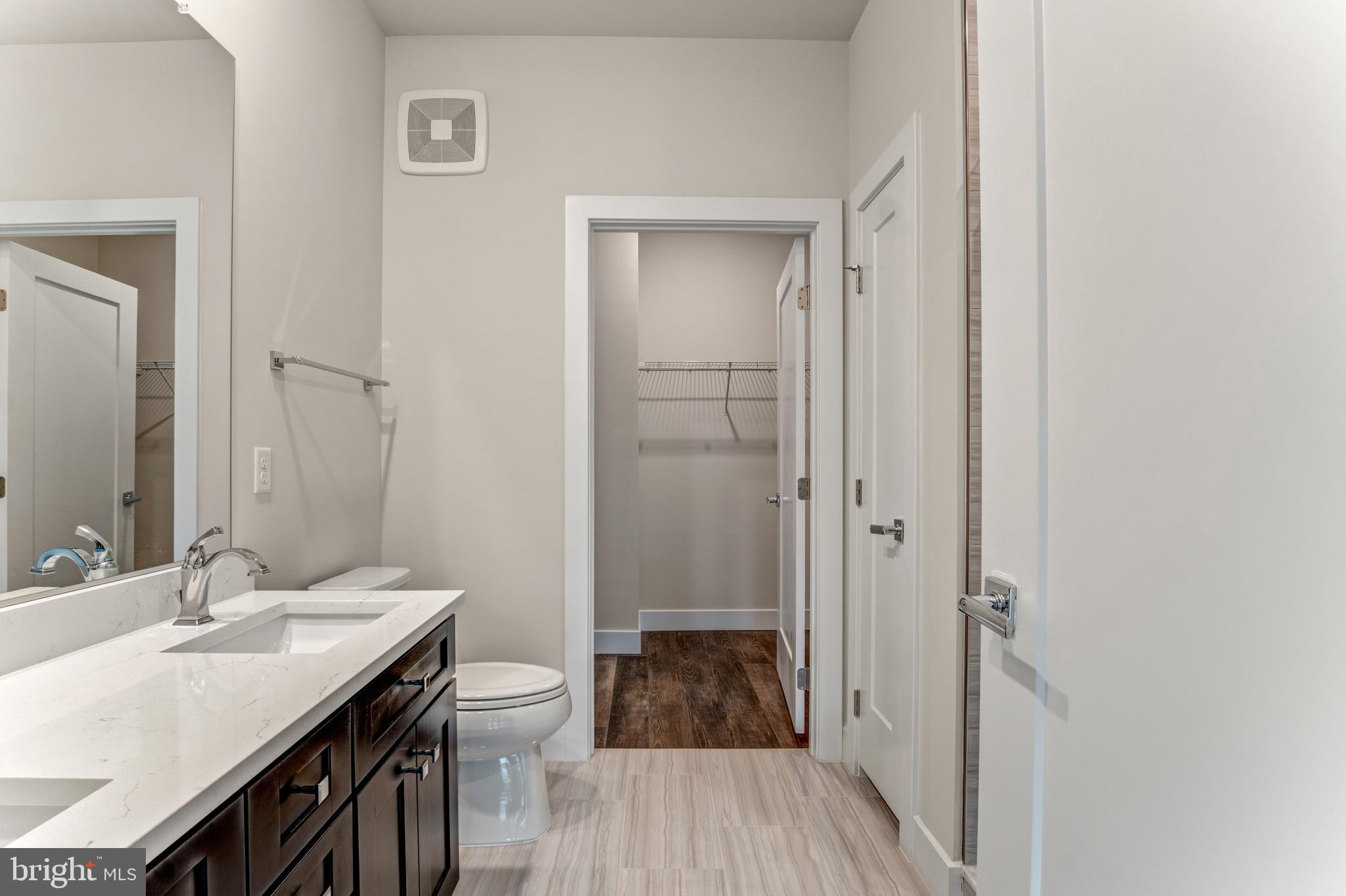 1761 Old Meadow Road, Unit 209 McLean, VA 22102 - Photo 15 of 49 a bathroom with a sink a toilet a shower and a mirror