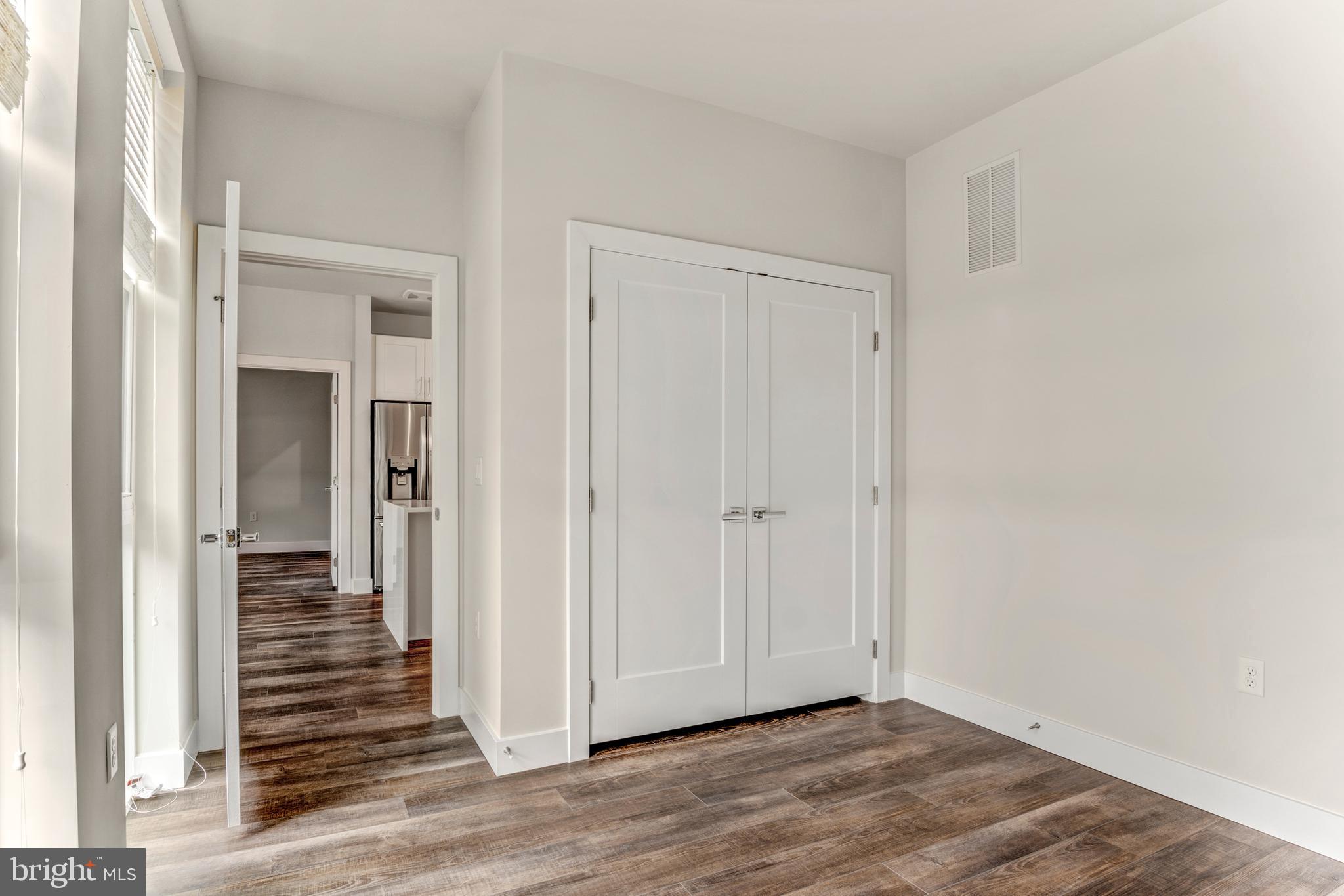 1761 Old Meadow Road, Unit 209 McLean, VA 22102 - Photo 19 of 49 a view of a hallway with wooden floor and entryway