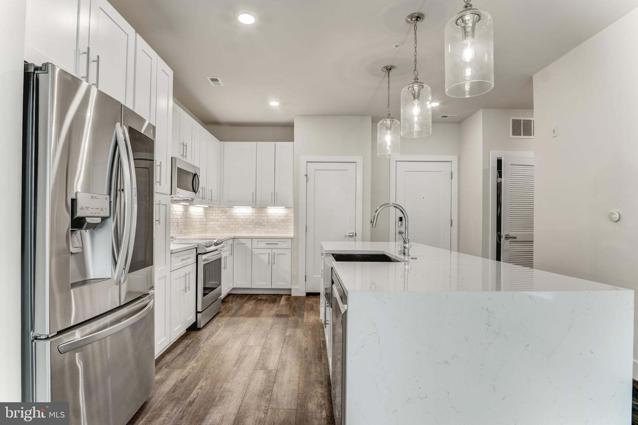 1761 Old Meadow Road, Unit 209 McLean, VA 22102 - Photo 3 of 49 a kitchen with stainless steel appliances a refrigerator sink and cabinets