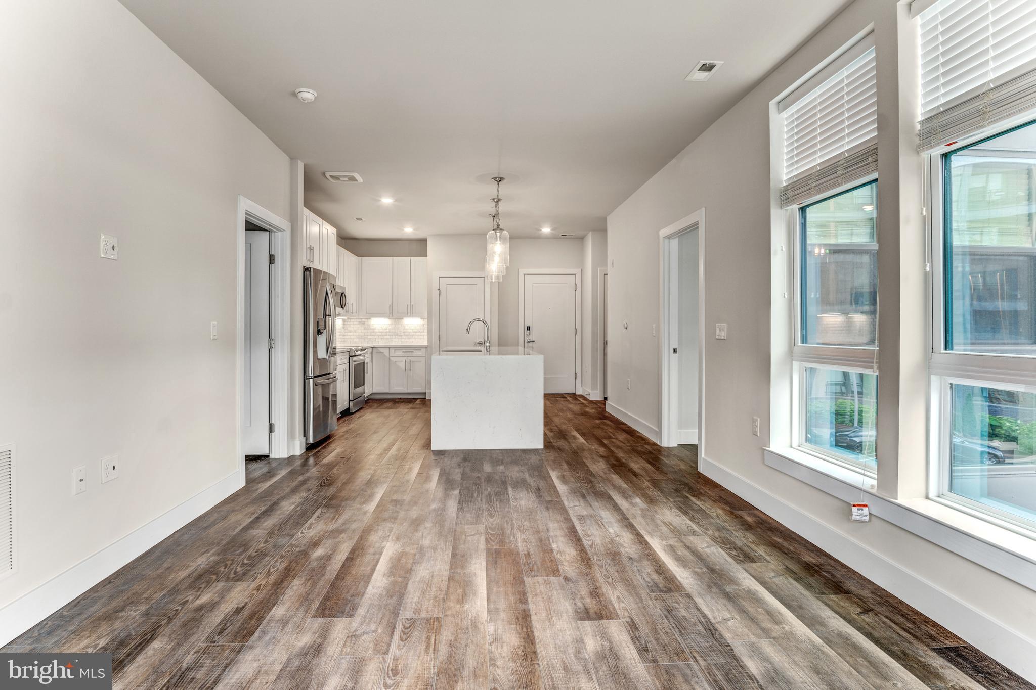 1761 Old Meadow Road, Unit 209 McLean, VA 22102 - Photo 7 of 49 a view of a hallway with wooden floor and a window