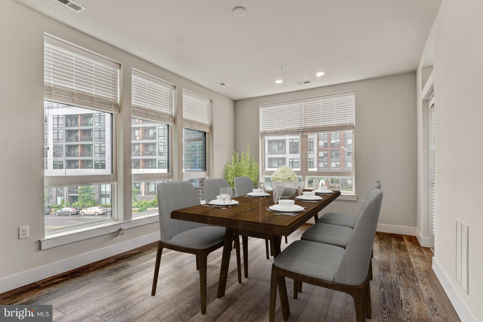 1761 Old Meadow Road, Unit 209 McLean, VA 22102 - Photo 10 of 49 a view of a dining room with furniture window and wooden floor