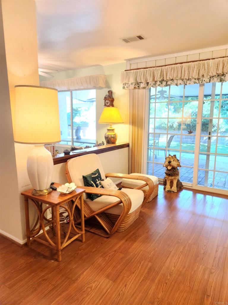1722 Firestone Drive Escondido, CA 92026 - Photo 25 of 72 a room with wooden floor and glass door