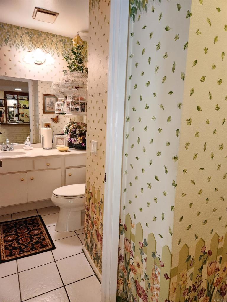 1722 Firestone Drive Escondido, CA 92026 - Photo 30 of 72 a bathroom with a toilet and a sink a mirror