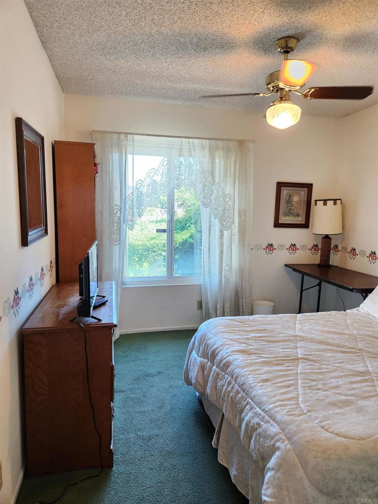 1722 Firestone Drive Escondido, CA 92026 - Photo 50 of 72 a bedroom with a bed and a flat tv screen on dresser