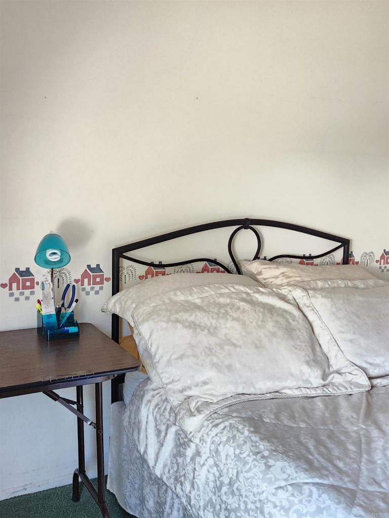 1722 Firestone Drive Escondido, CA 92026 - Photo 51 of 72 a bedroom with a bed and a table in it