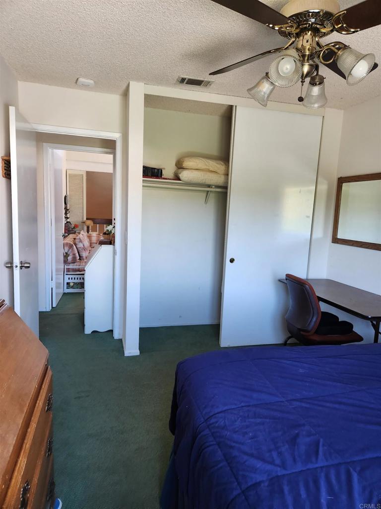 1722 Firestone Drive Escondido, CA 92026 - Photo 55 of 72 a bedroom with a bed and a mirror