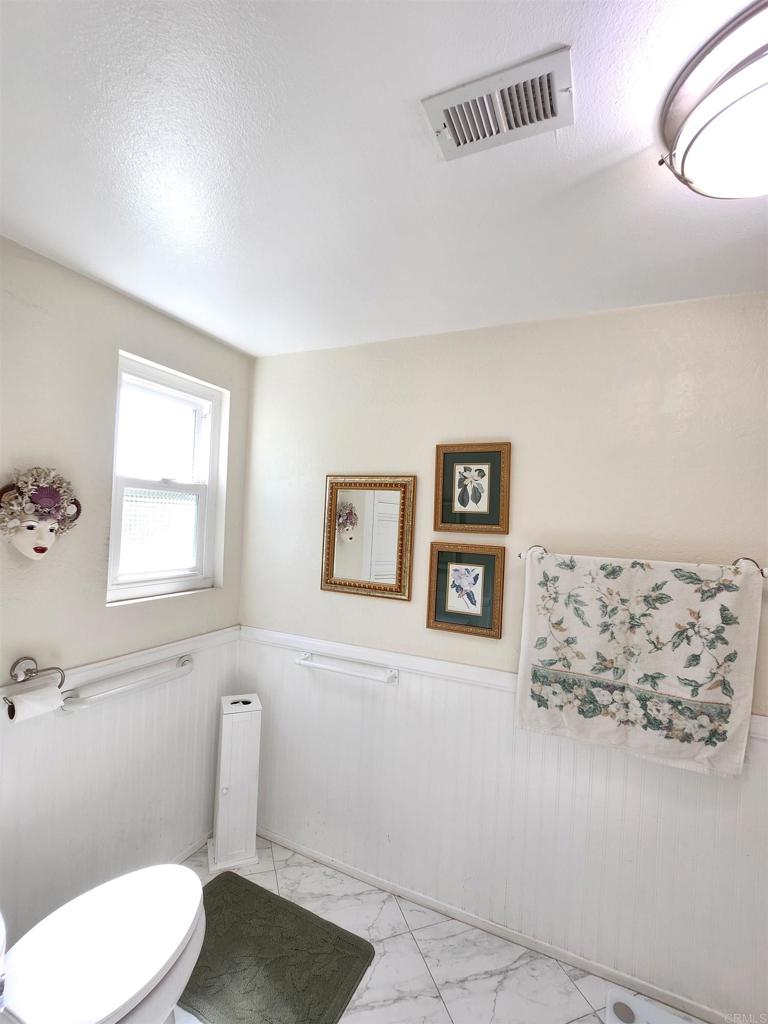 1722 Firestone Drive Escondido, CA 92026 - Photo 61 of 72 a white toilet sitting next to a window