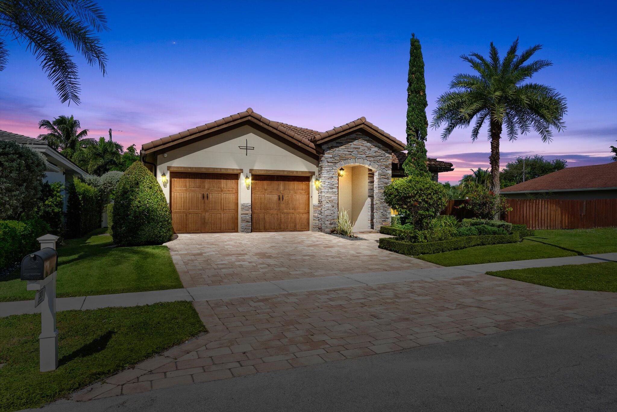 1301 Southwest 15th Street Boca Raton, FL 33486 - Photo 2 of 54 a front view of a house with a yard and garage
