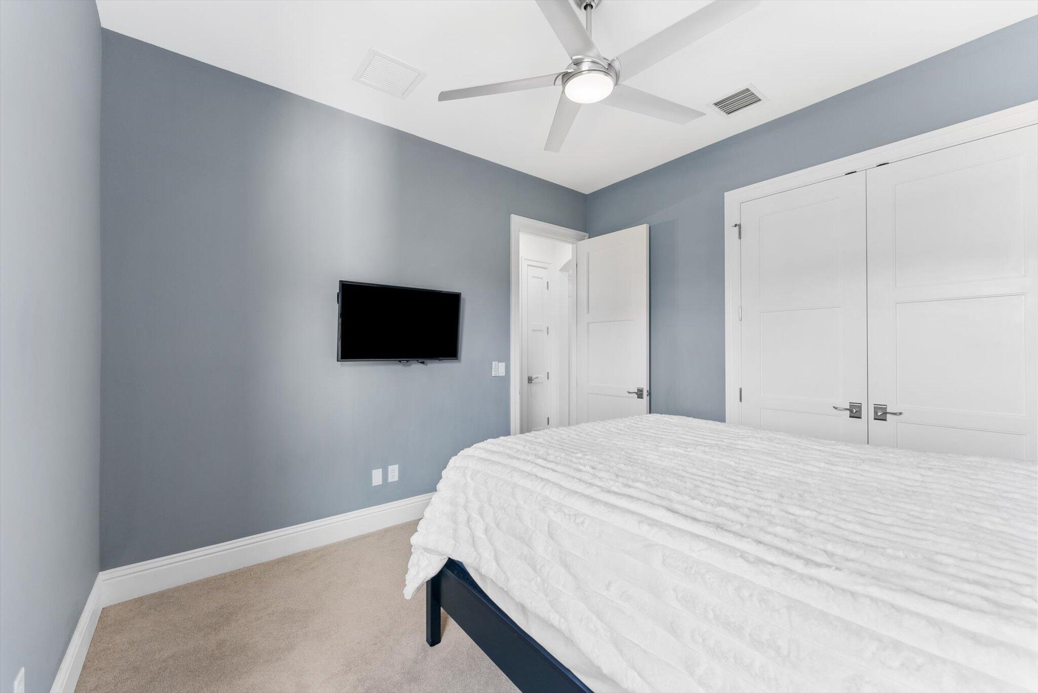 1301 Southwest 15th Street Boca Raton, FL 33486 - Photo 36 of 54 a bedroom with a bed and a flat screen tv