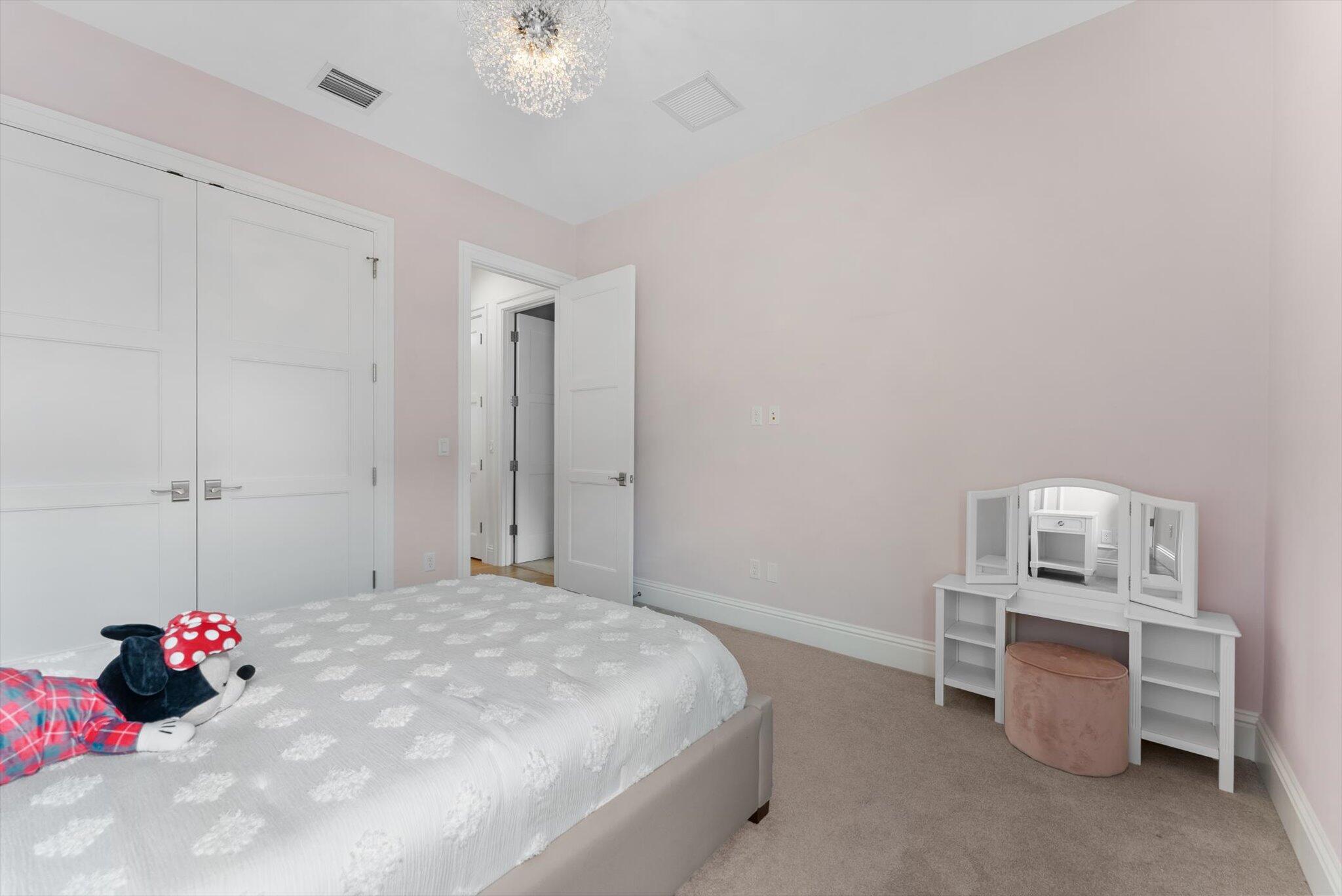 1301 Southwest 15th Street Boca Raton, FL 33486 - Photo 39 of 54 a bedroom with a bed and a chandelier