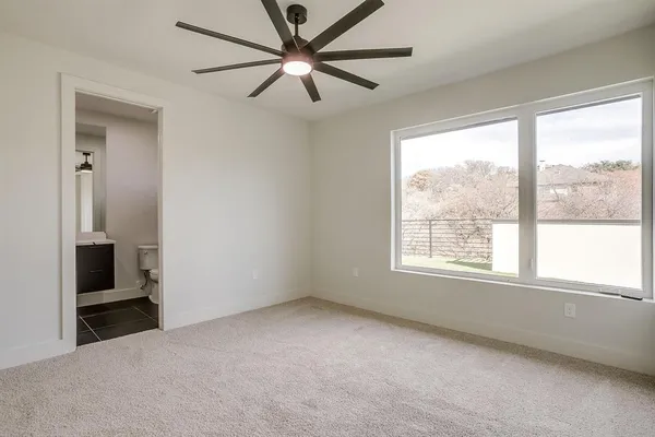 a view of room with window and a ceiling fan
