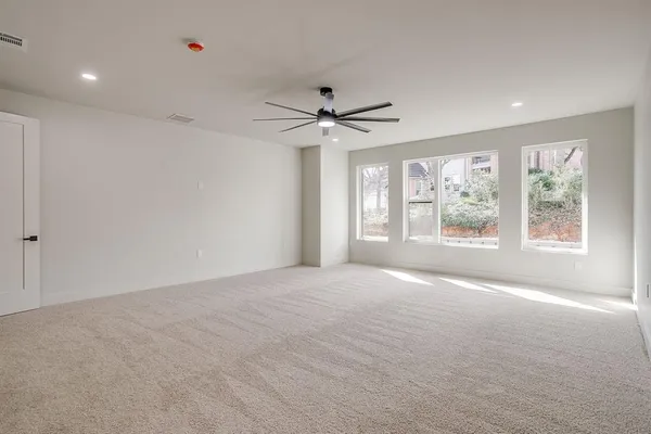 a living room with furniture and a floor to ceiling window