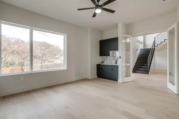 a view of a kitchen with kitchen island a sink stainless steel appliances and a counter top space