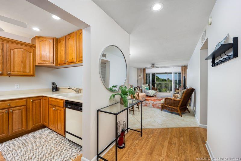 a kitchen with stainless steel appliances granite countertop a stove a sink dishwasher and a microwave oven with cabinets