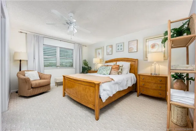 a bedroom with a bed couch and window