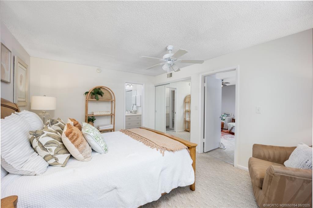 1550 Northeast Ocean Boulevard, Unit B304 Stuart, FL 34996 - Photo 13 of 19 a bedroom with a bed and a couch