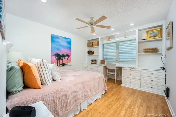 a spacious bedroom with a bed and a dresser