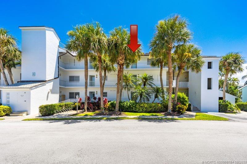 1550 Northeast Ocean Boulevard, Unit B304 Stuart, FL 34996 - Photo 15 of 19 a group of palm trees sitting in front of a building