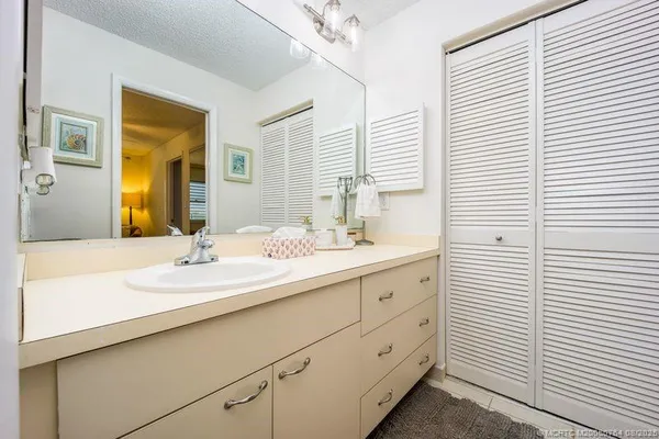 a bathroom with a sink a mirror and a shower