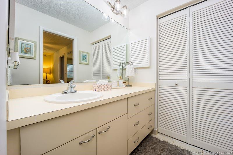 1550 Northeast Ocean Boulevard, Unit B304 Stuart, FL 34996 - Photo 17 of 19 a bathroom with a sink a mirror and a shower