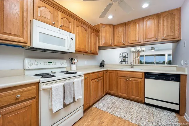 a kitchen with stainless steel appliances granite countertop a stove and cabinets