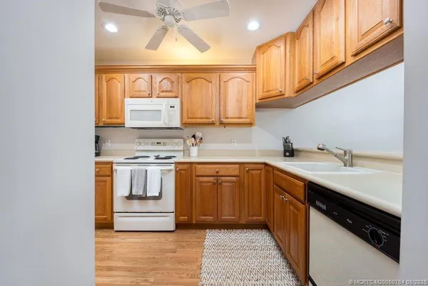 a kitchen with stainless steel appliances granite countertop a sink and cabinets