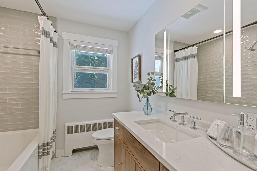 9 Baskin Road Lexington, MA 02421 - Photo 23 of 39 a bathroom with a granite countertop sink toilet and shower